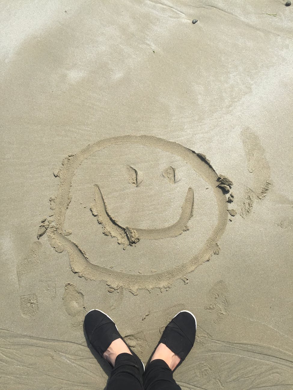 smiley drawing on sand